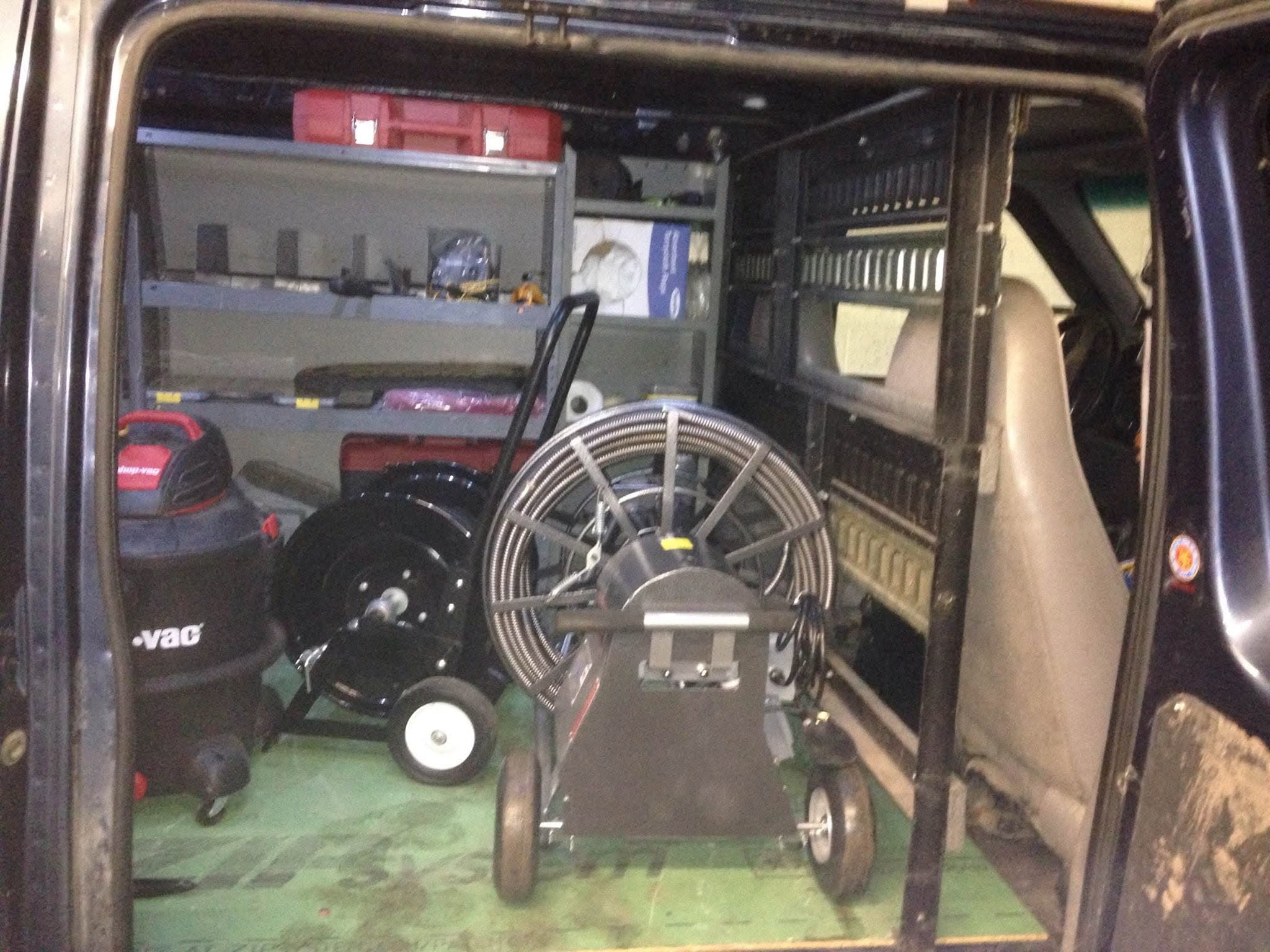 Organized service van stocked with drain equipment